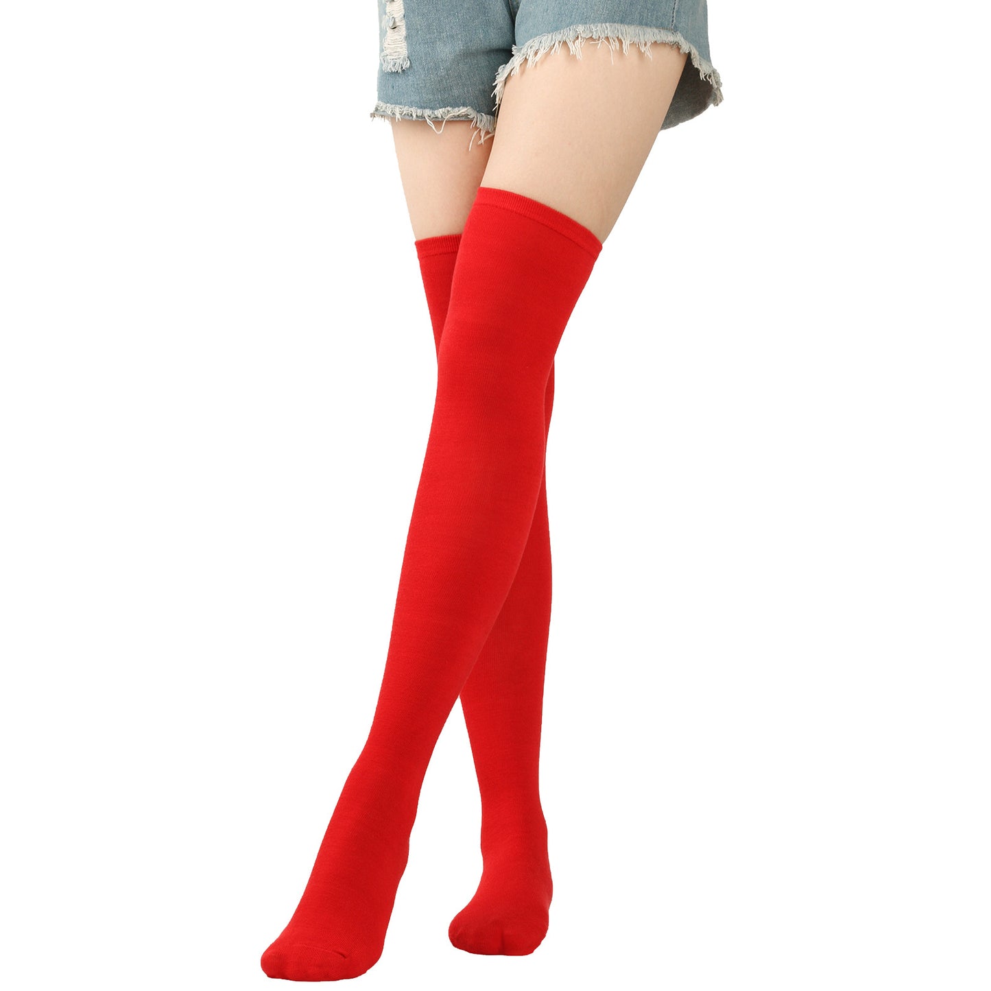 Red knee-high socks worn with denim shorts on a white background
