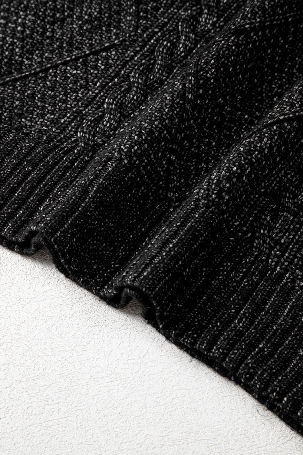 Close-up of black textured fabric knit sweater dress