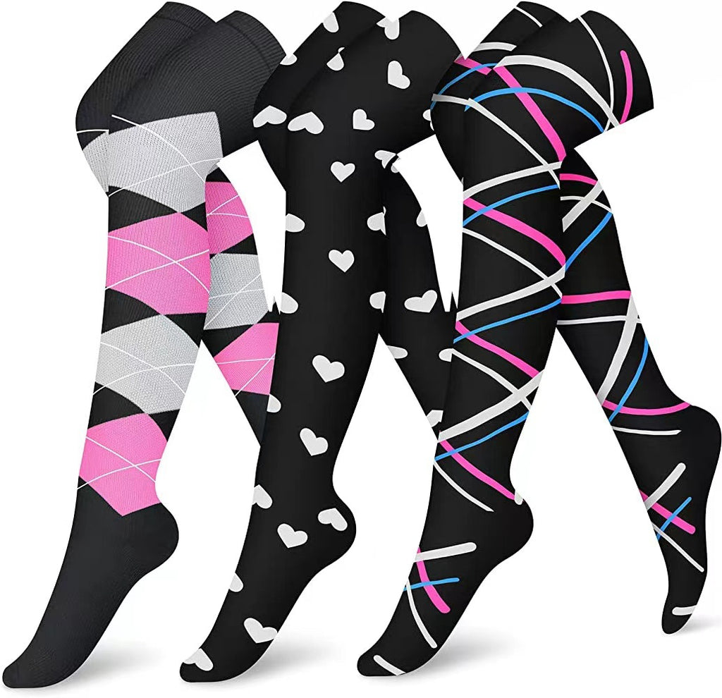Three pairs of patterned socks with pink, gray, and blue designs on a white background.