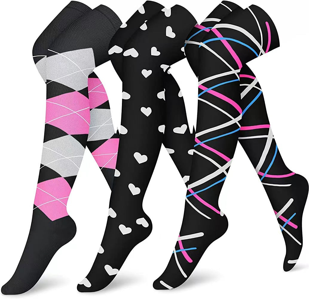 Three pairs of patterned socks with pink, gray, and blue designs on a white background.