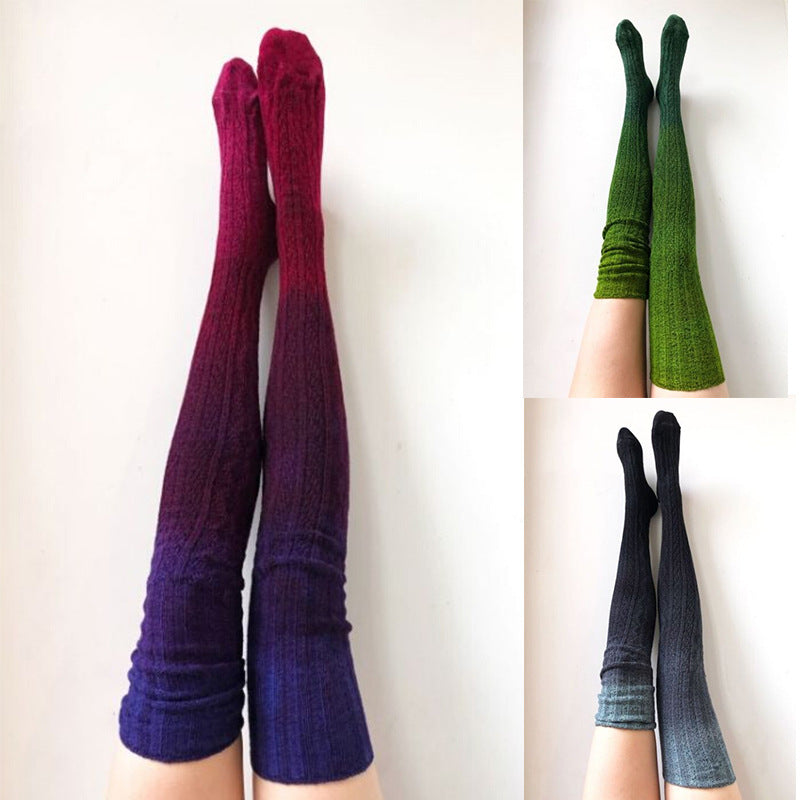 Three pairs of gradient socks in purple, green, and blue on a white background.