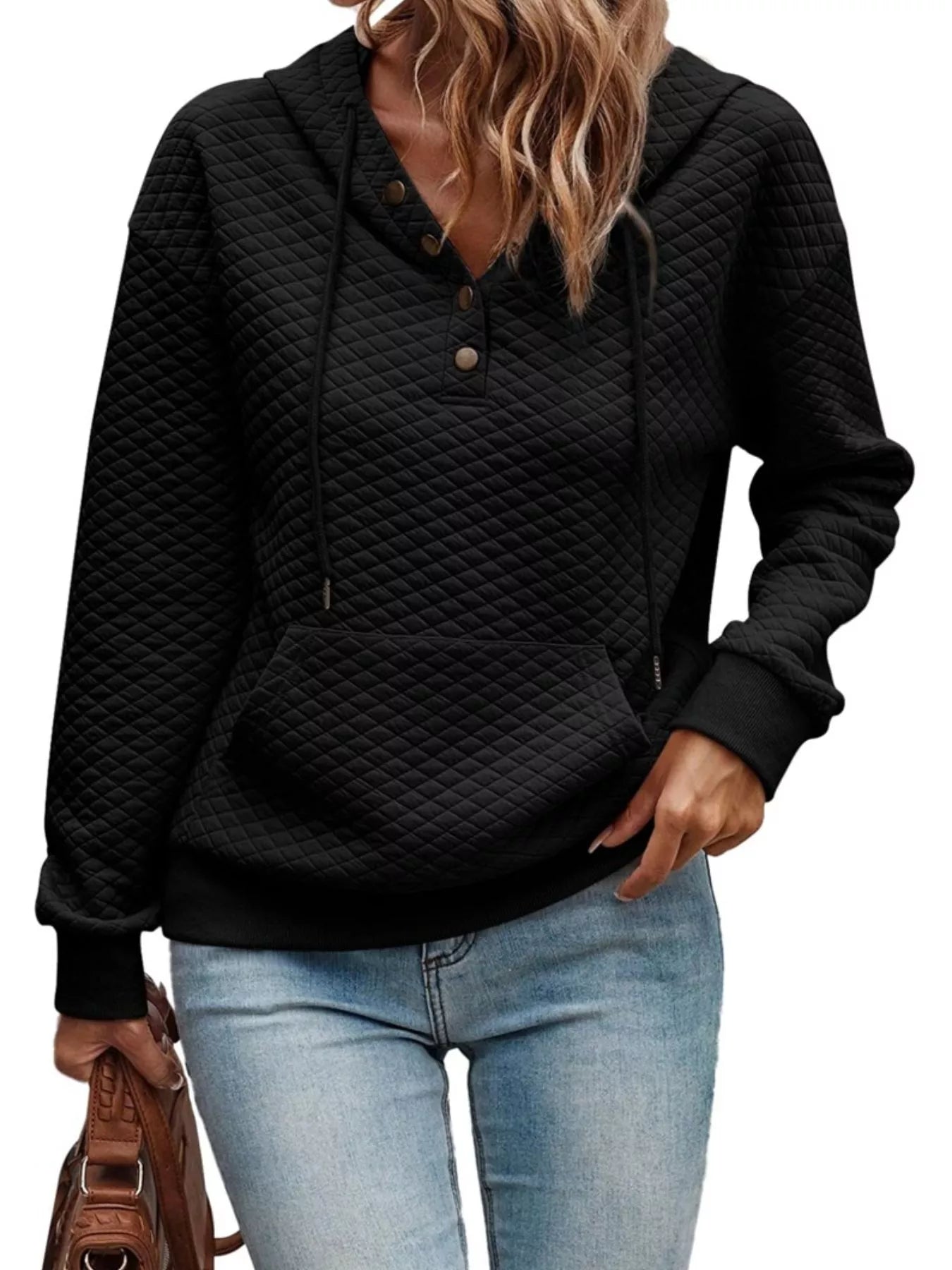 Black quilted hoodie worn by a person on a white background