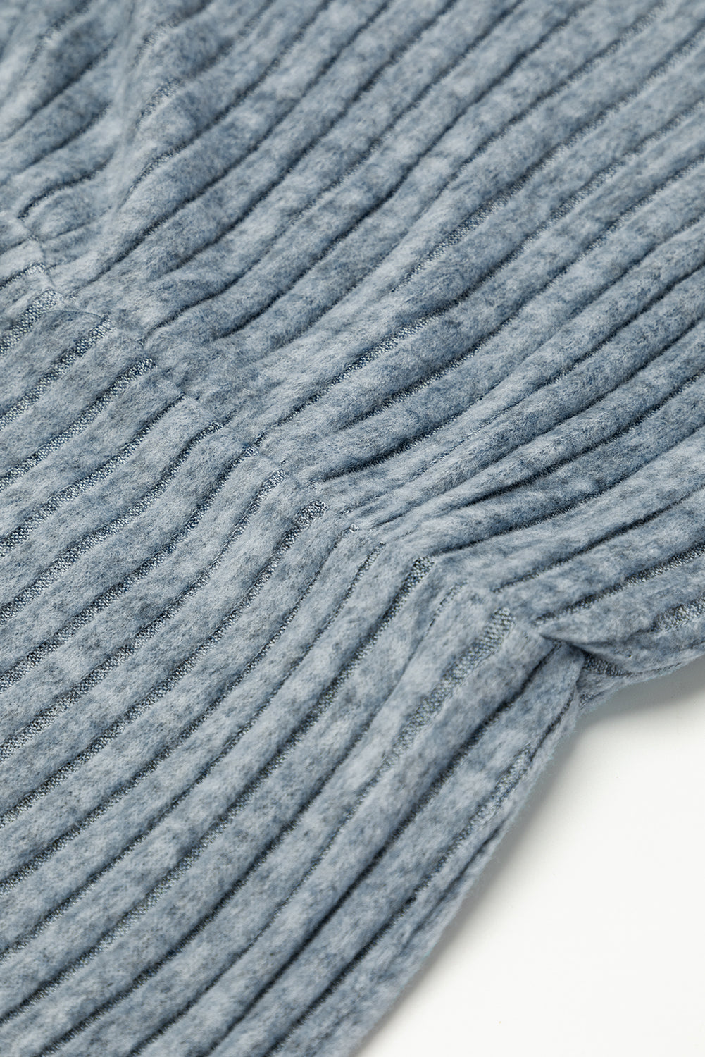 Close-up of textured blue fabric on a white background