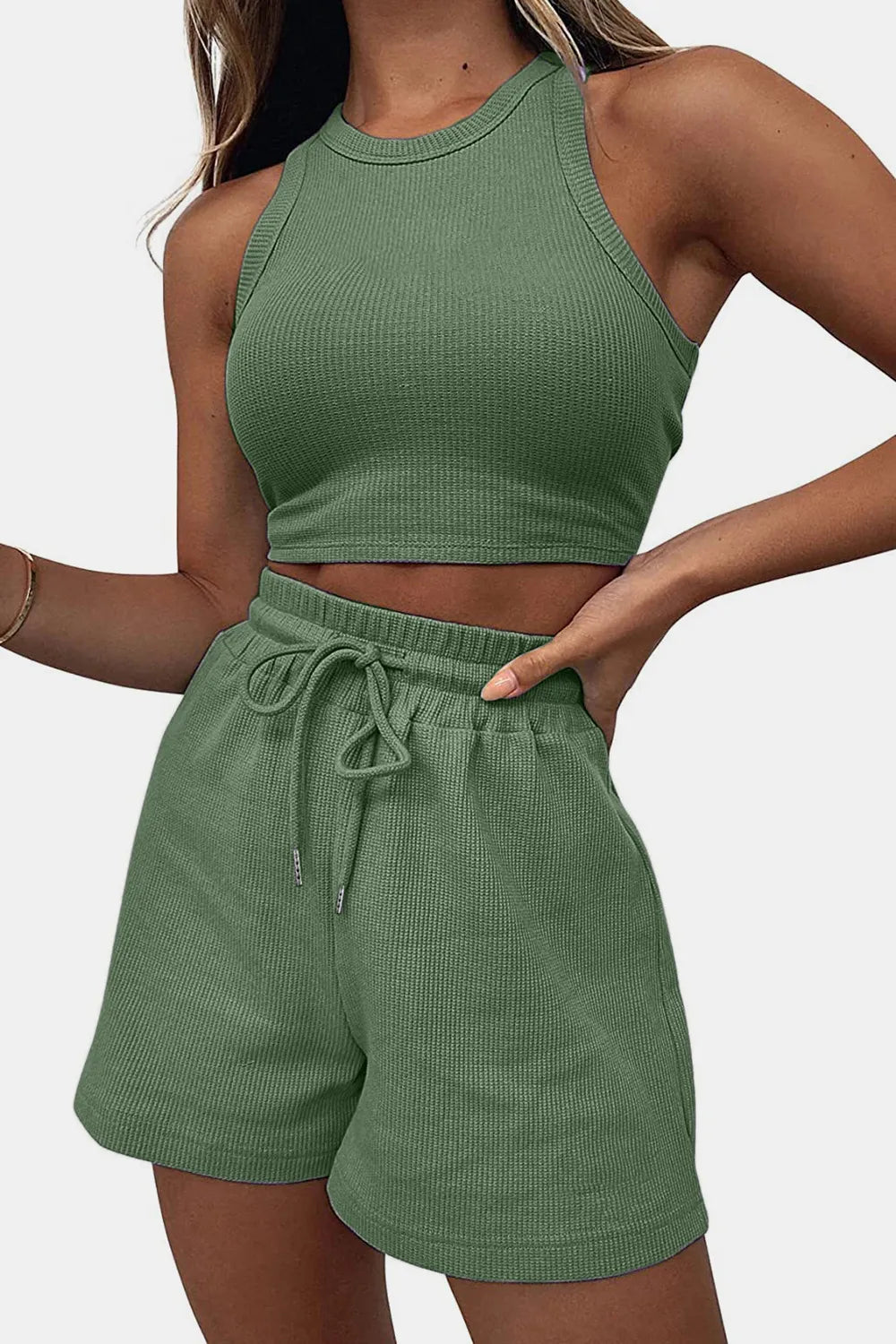 Green ribbed tank top and shorts set on a plain background