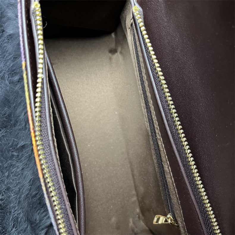 Close-up of a dark-colored jacket with a zipper