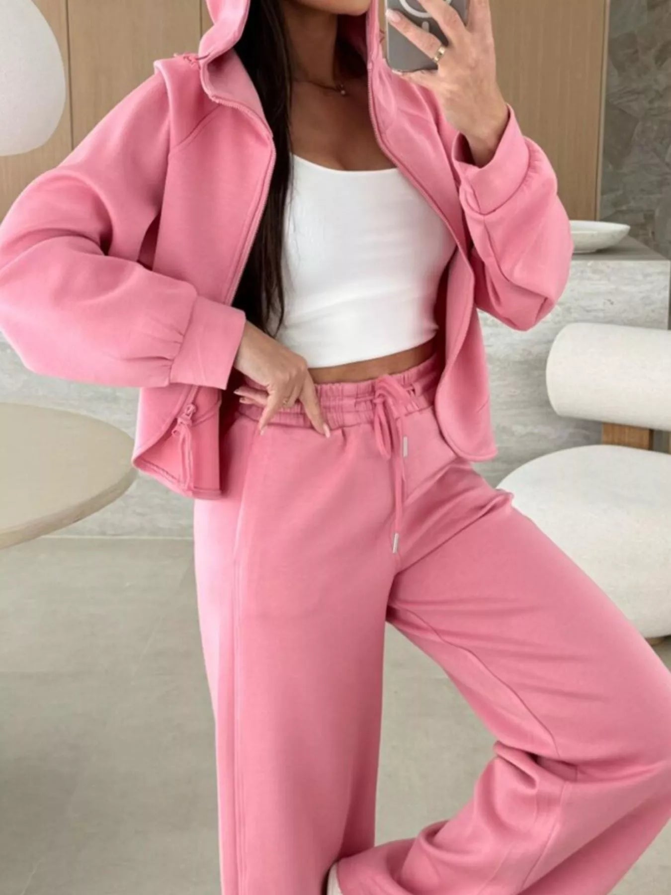 Person wearing a pink tracksuit in an indoor setting