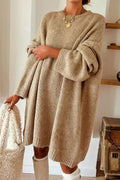 Model wearing a Women's Khaki Exposed Seam Mini Sweater Dress holding a textured handbag.