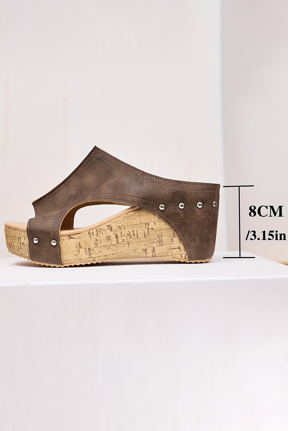 Brown wedge sandal with cork sole on a white background
