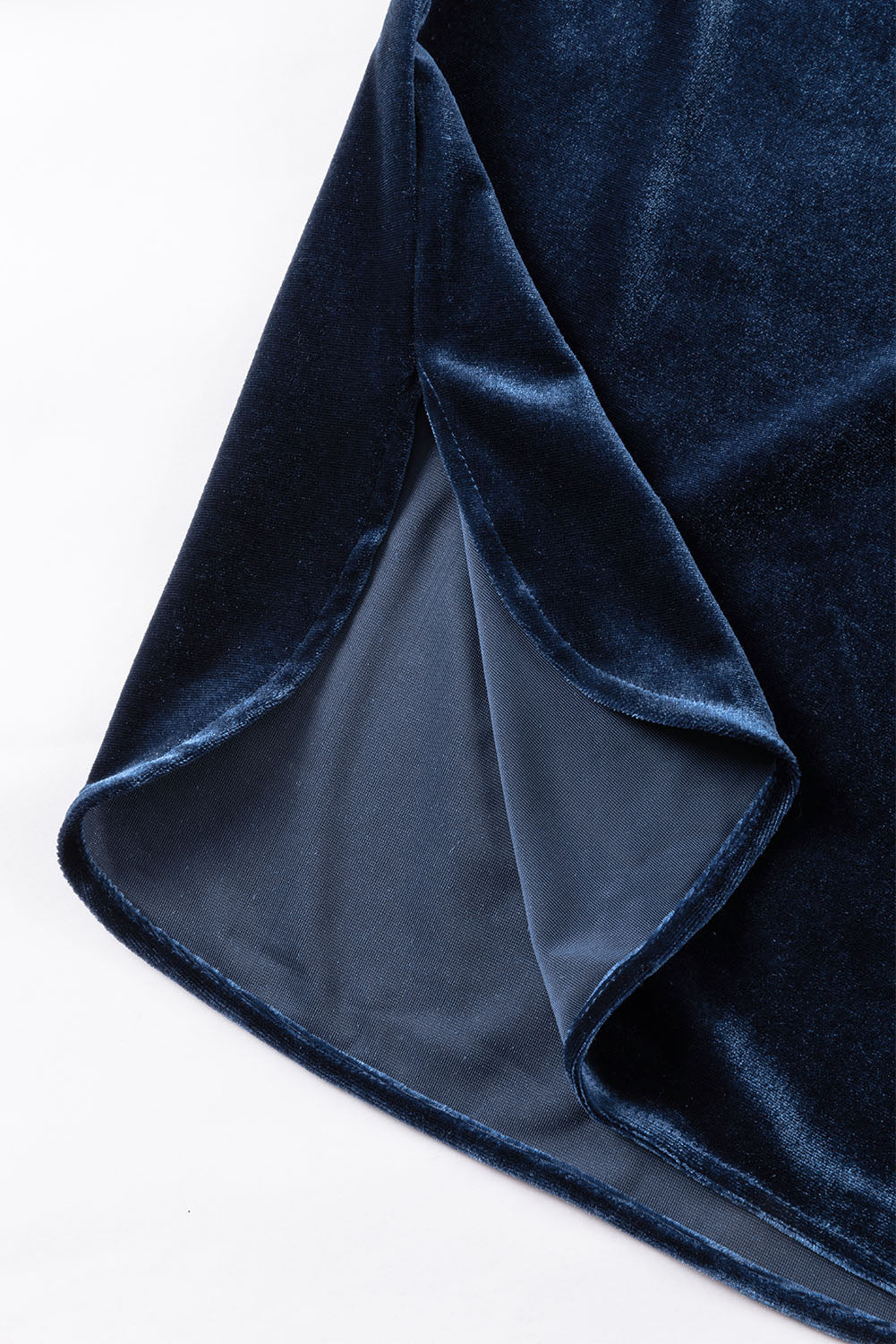 Close-up of dark blue velvet fabric on a white background