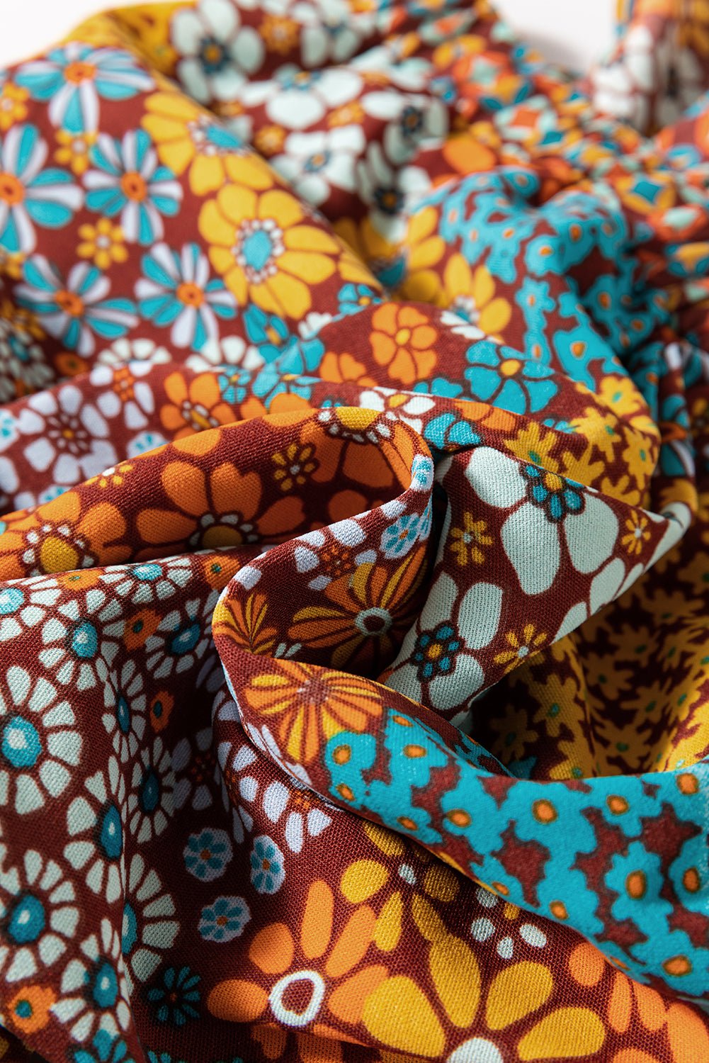 Close-up of colorful floral fabric with a pattern of flowers in various colors.