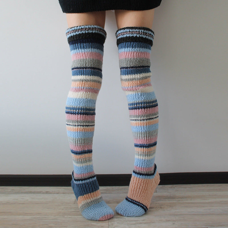 Colorful striped knee-high socks worn by a person on a plain background