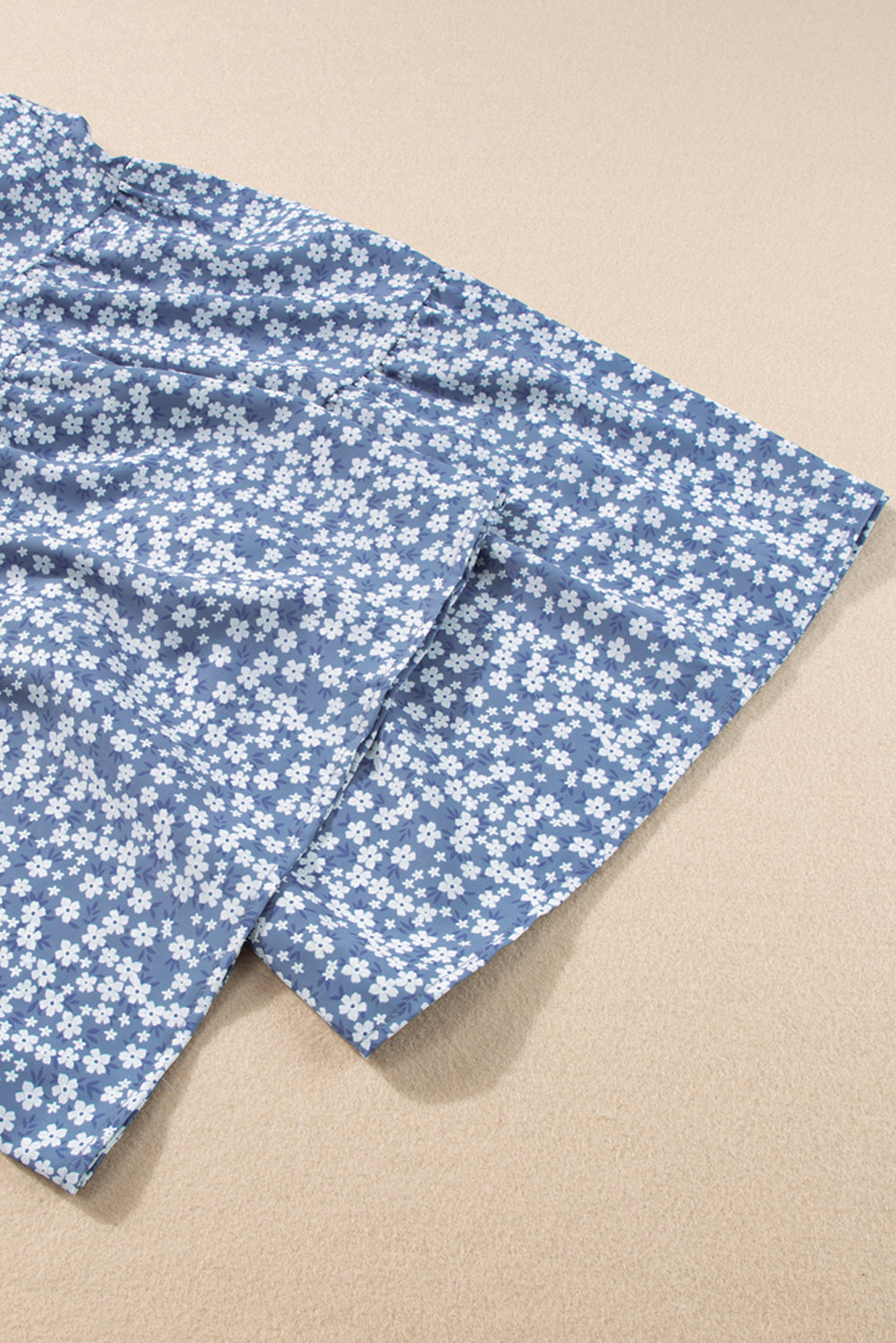 Blue floral fabric on a beige background