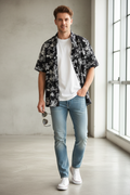 Model wearing a Men's Flower Printed Button Up black Short Sleeve Shirt