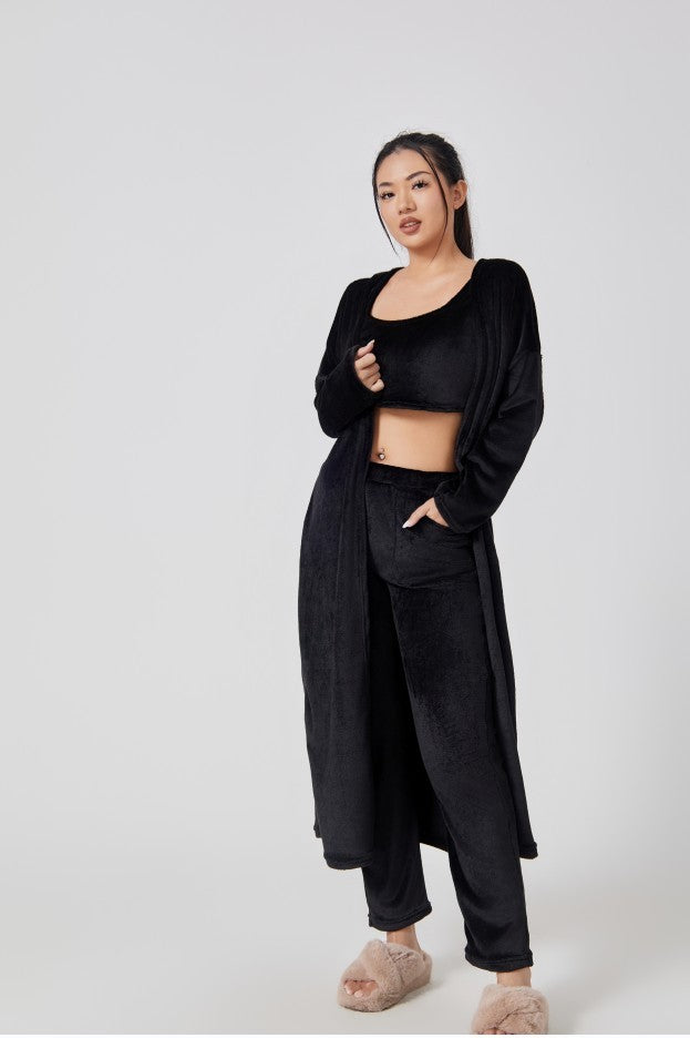 Woman wearing a black outfit on a white background