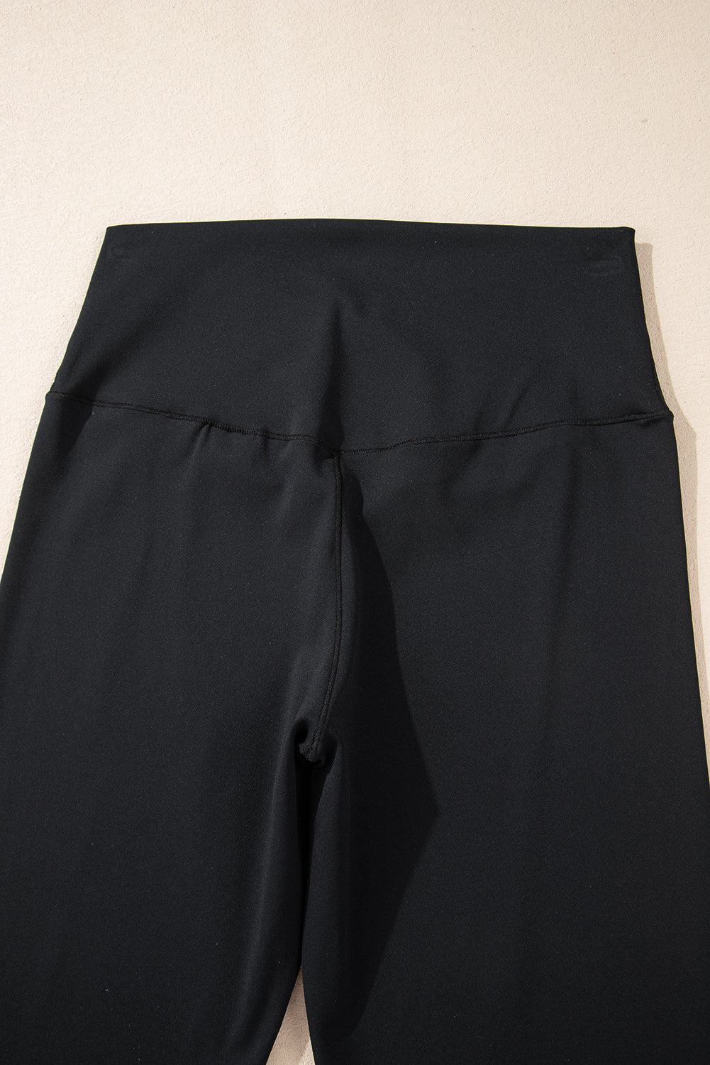 Black pants on a beige background