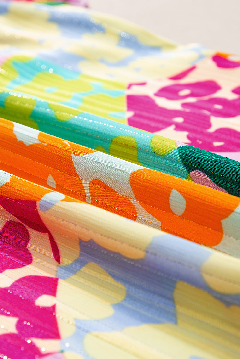 Colorful patterned fabric with abstract designs in various colors.