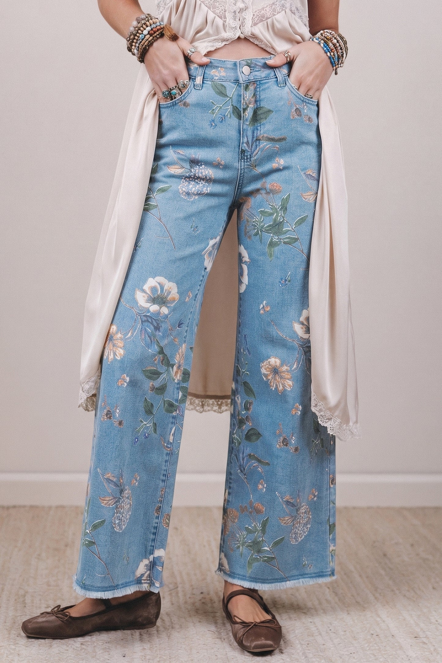 Person wearing floral jeans with a plain background