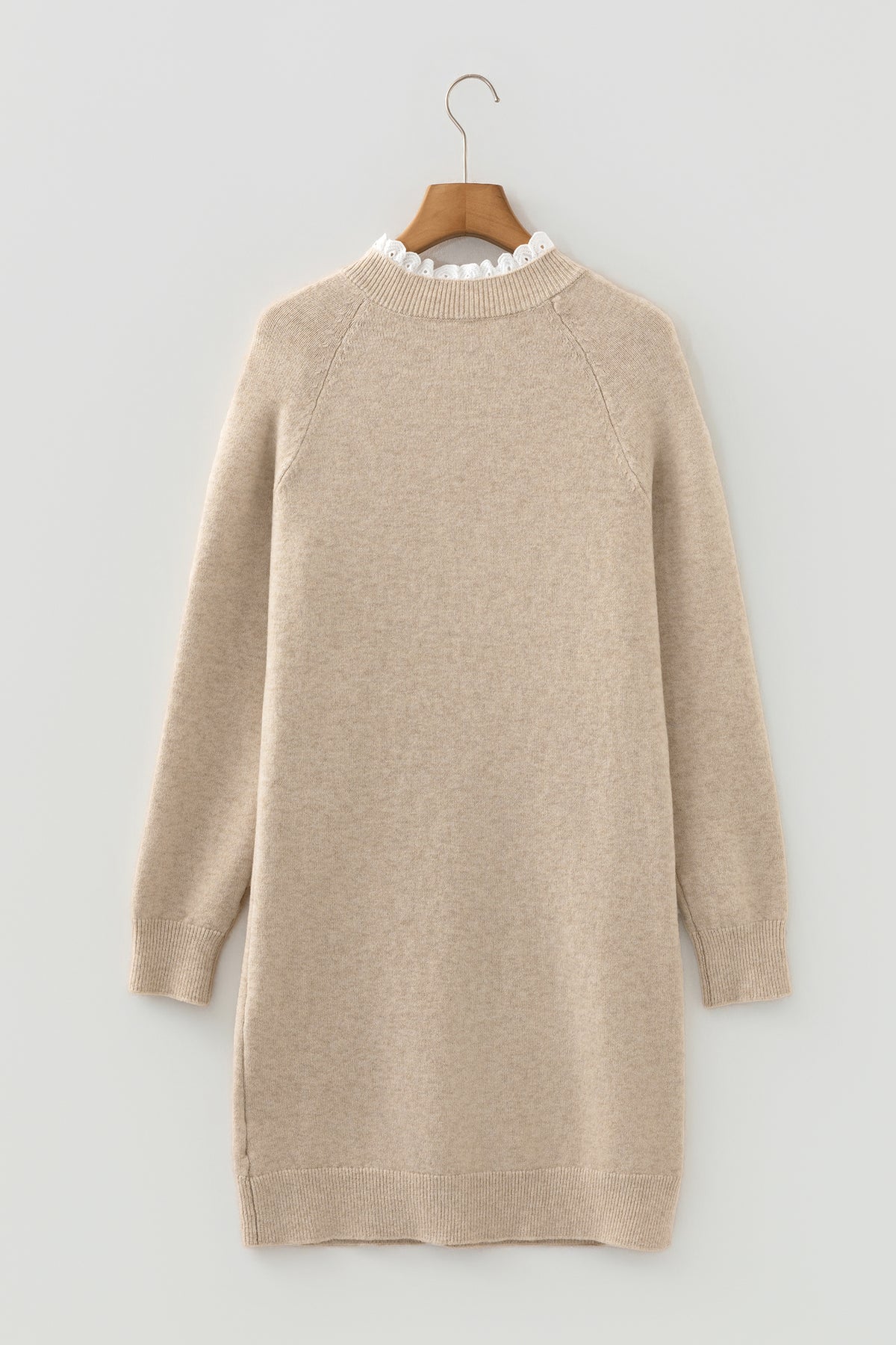 Beige Cross Shoulder Mini Sweater Dress on a wooden hanger back view