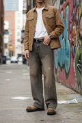 Male model wearing a pair of Paint Splatter Wide Leg Jeans