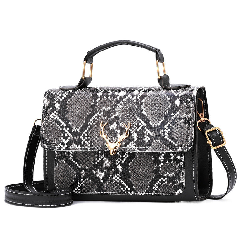 Black and white patterned handbag with gold accents on a white background