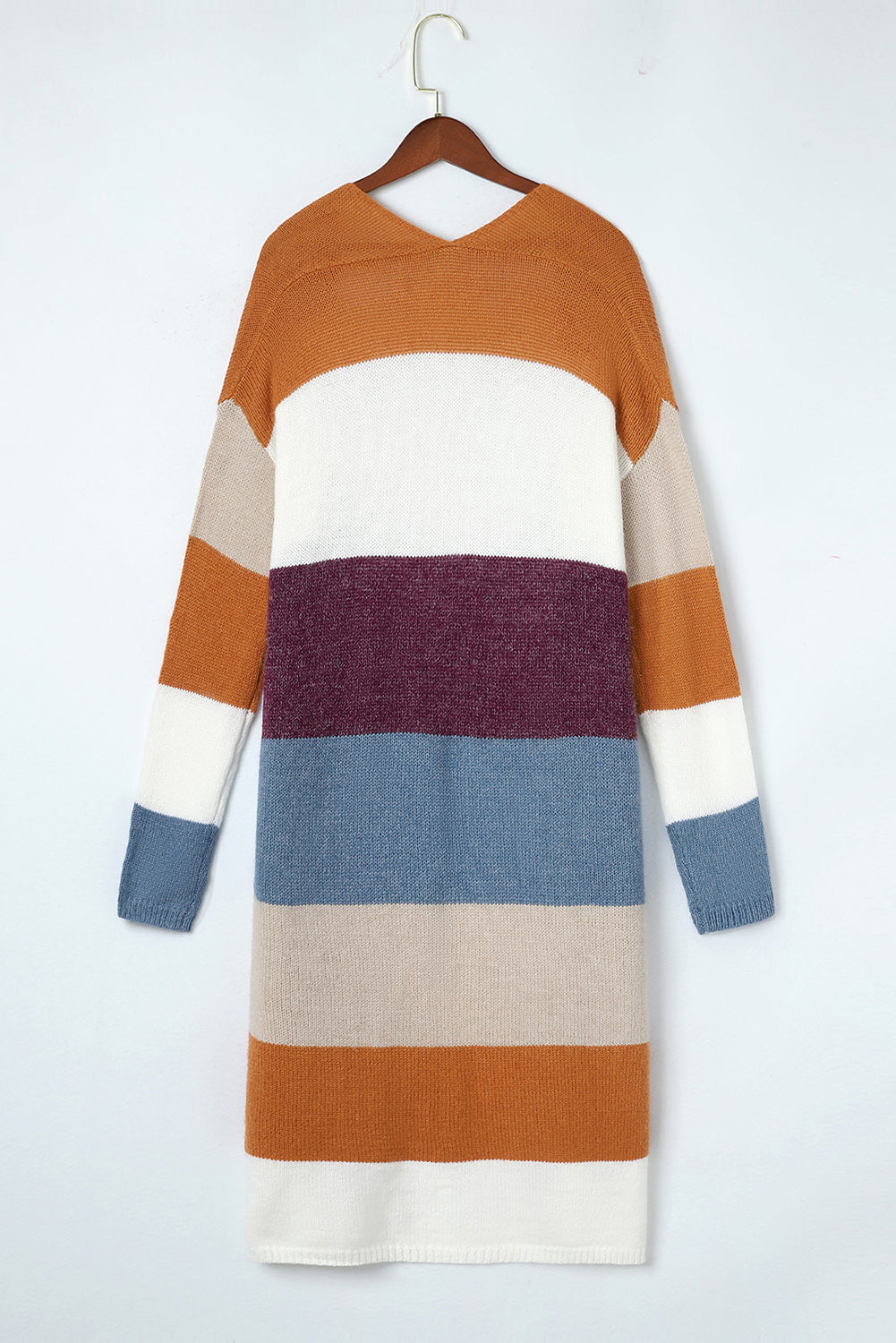 Color-blocked sweater dress on a hanger against a white background