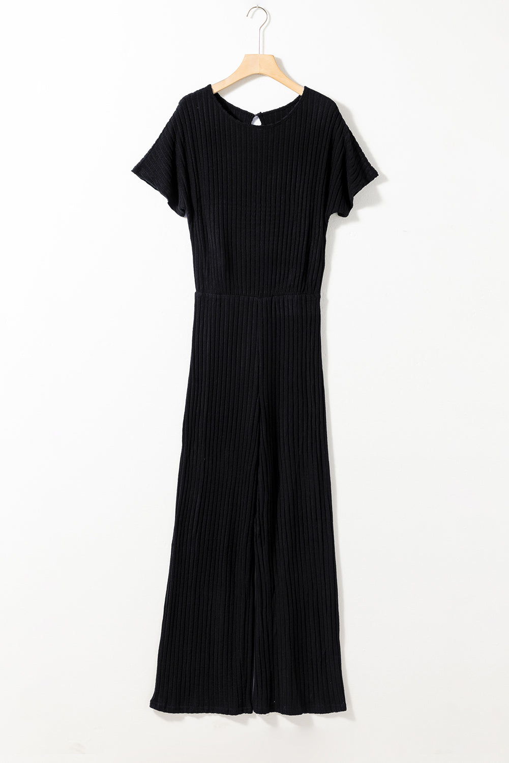 Black dress on a hanger against a white background