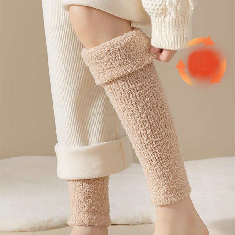 Beige fuzzy leg warmers worn with white pants on a neutral background