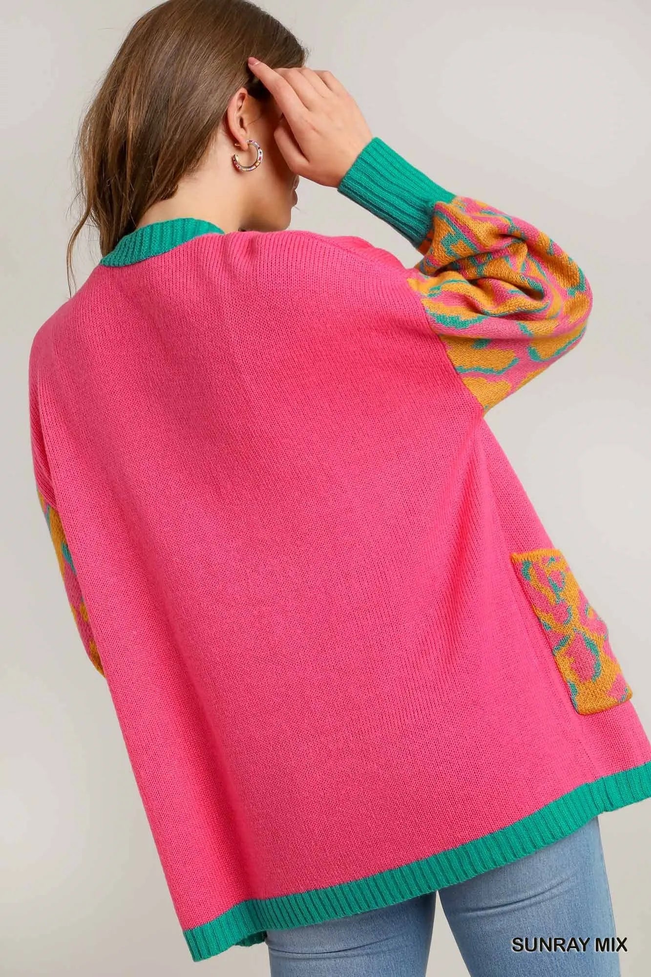 Back view of the vibrant pink cardigan highlighting the relaxed fit.