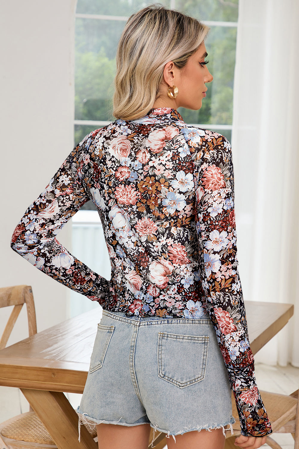 Back view of the model wearing the brown floral top displaying its fit.