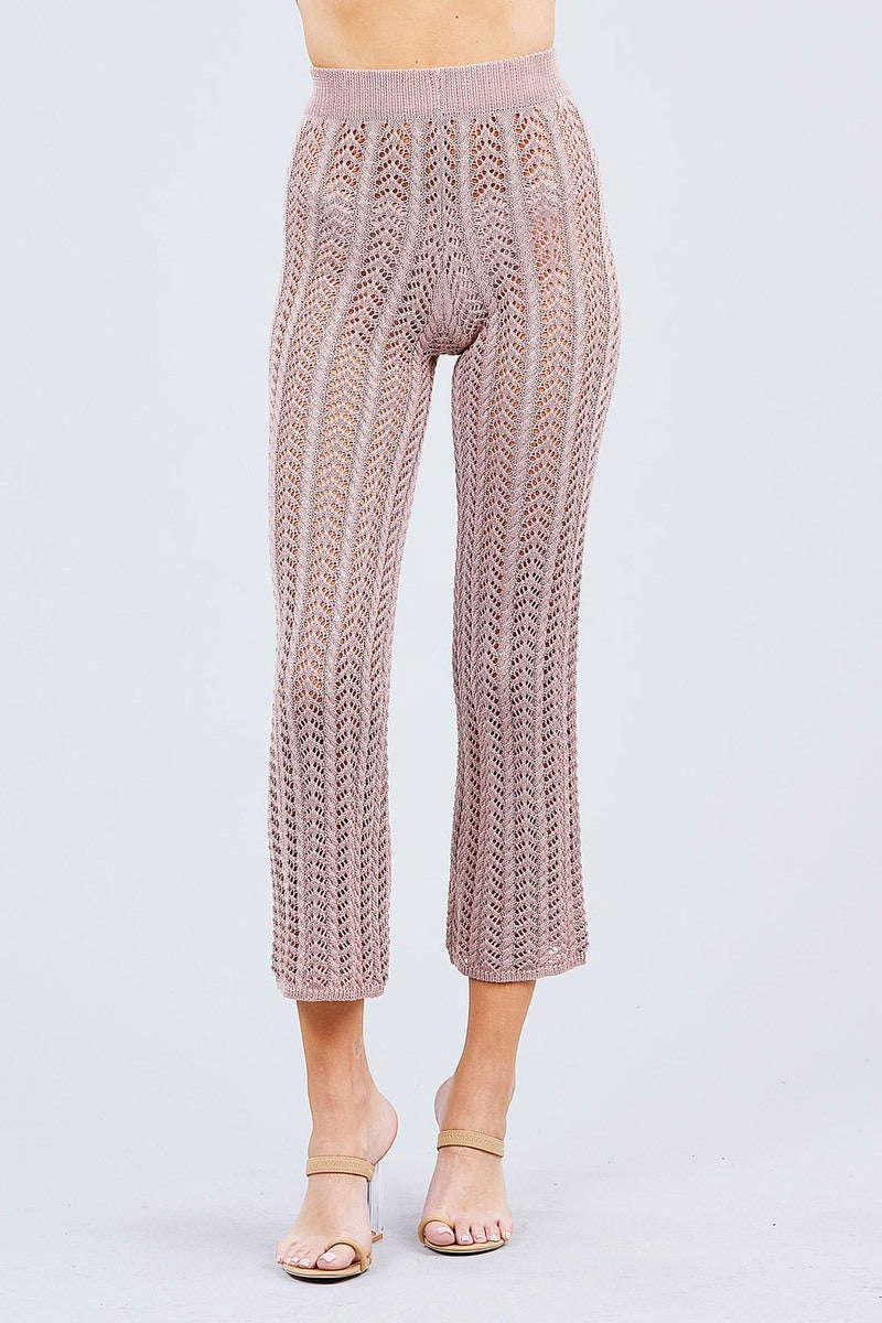Knitted Blush pink pants worn by a person on a light gray background