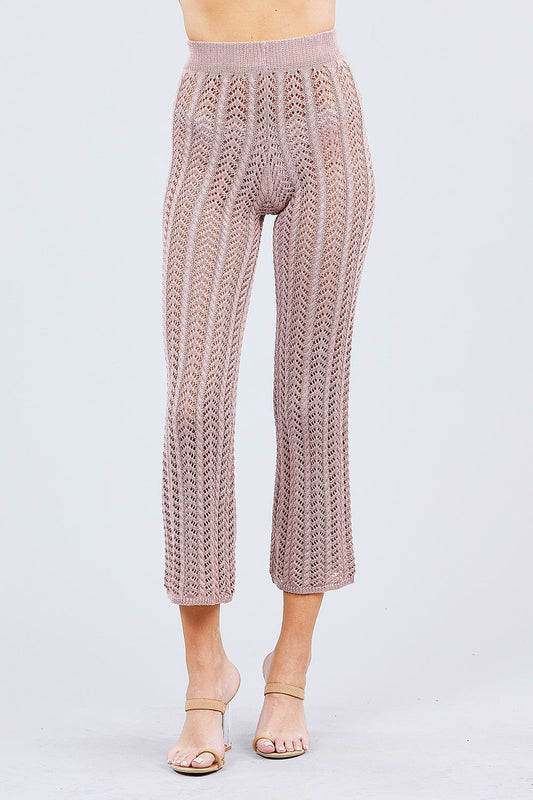 Knitted Blush pink pants worn by a person on a light gray background
