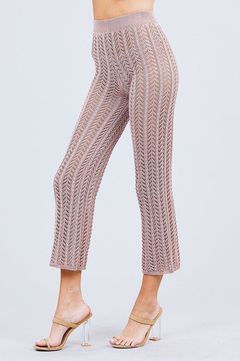 Knitted Blush pink pants worn by a person on a light gray background side view