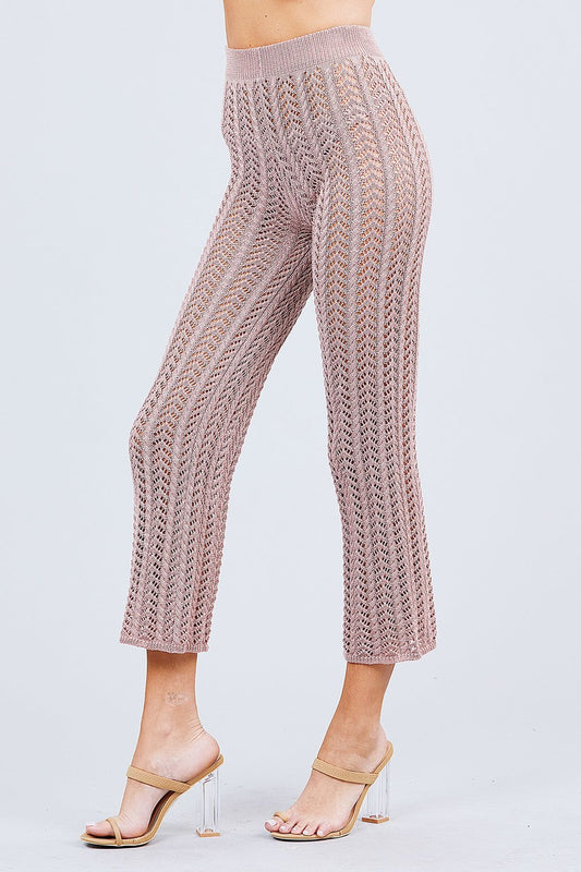 Knitted Blush pink pants worn by a person on a light gray background side view