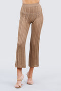 Khaki knitted pants worn by a person on a light gray background