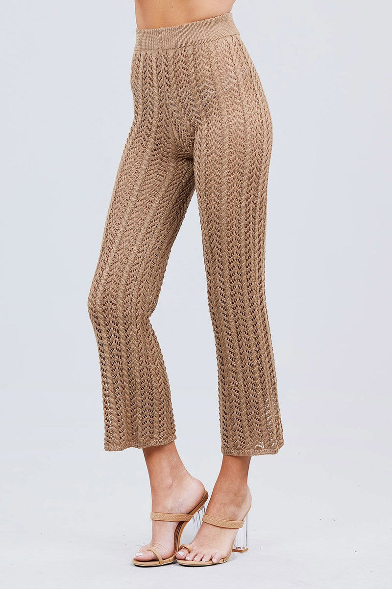 Khaki knitted pants worn by a person on a light gray background side view