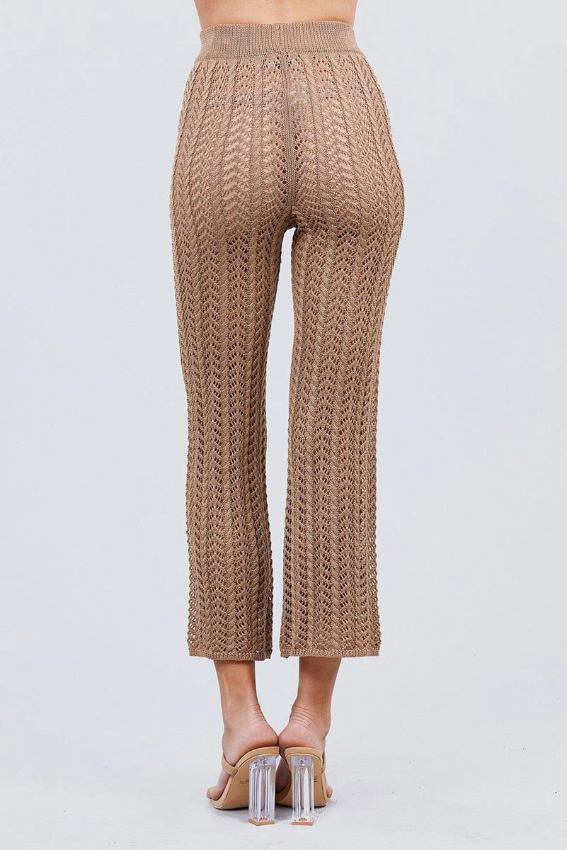 Khaki knitted pants worn by a person on a light gray background back view