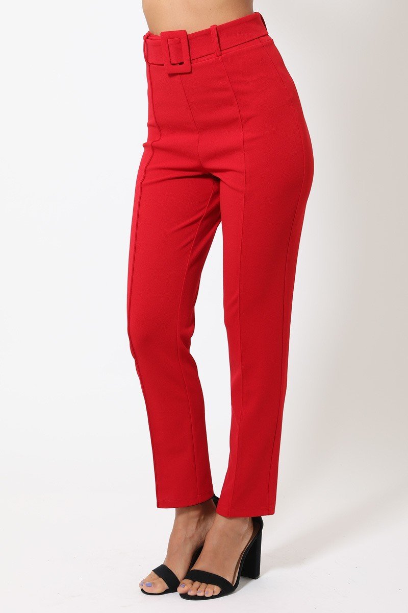 Red pants worn by a person on a white background side view