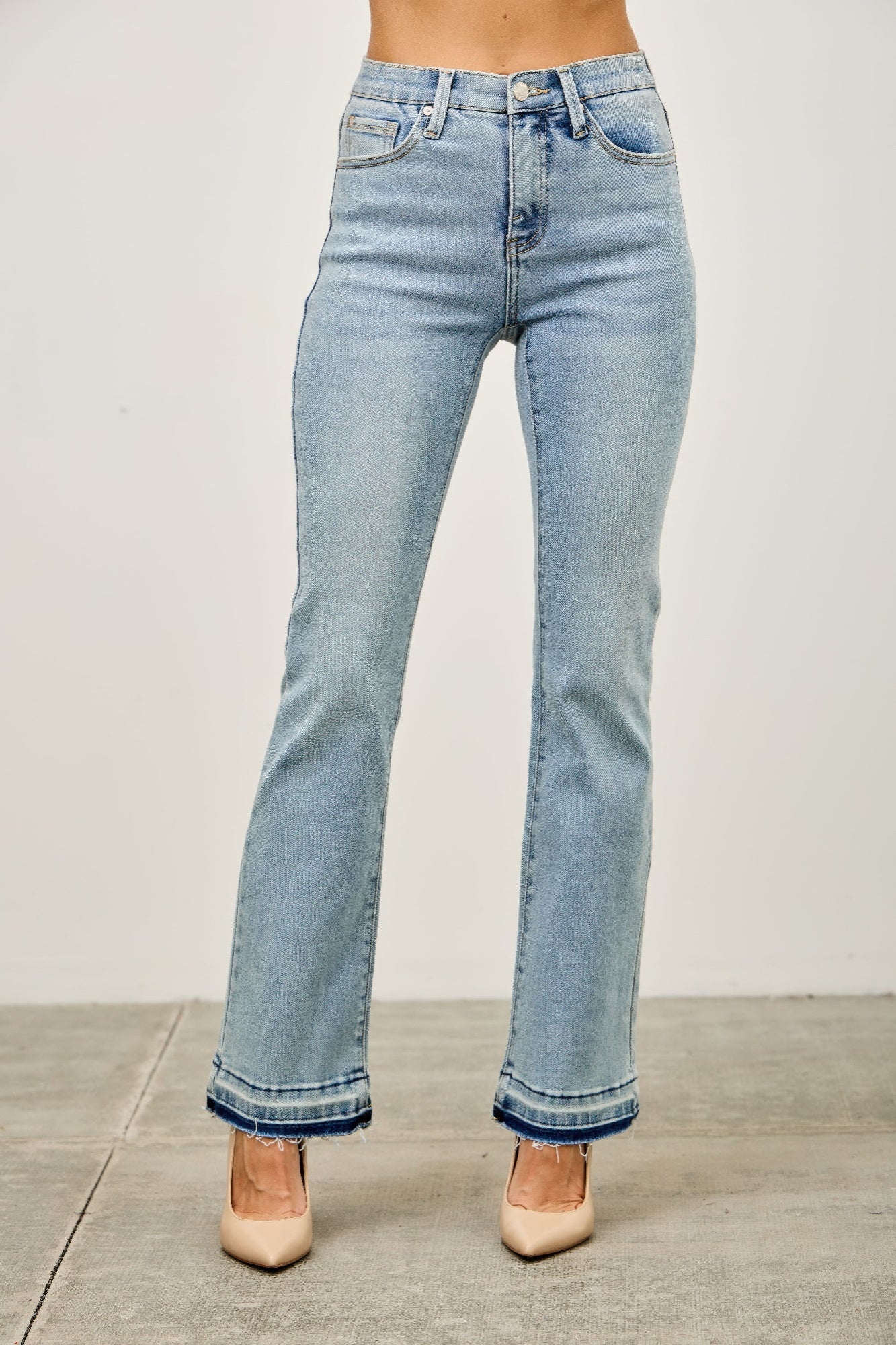 Light blue jeans worn by a person on a plain background