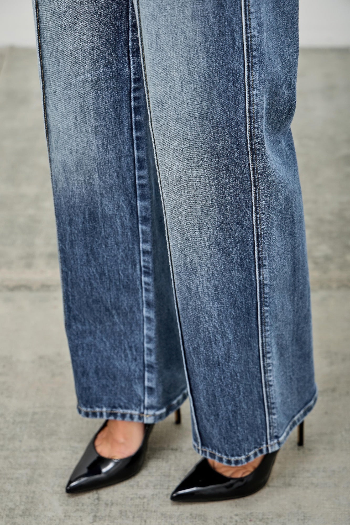 Close-up of pintuck blue jeans hem