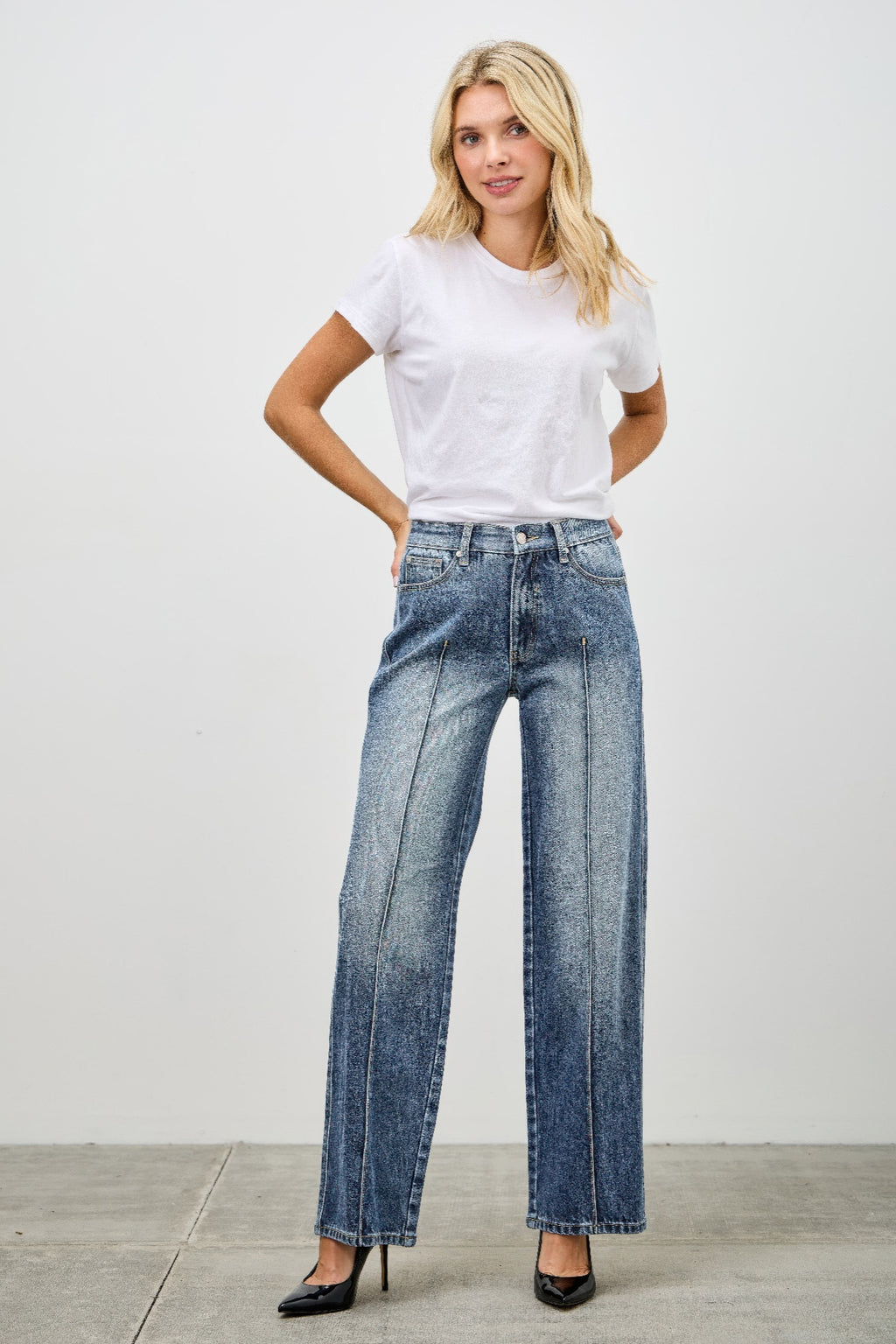 Woman wearing a white t-shirt and blue pintuck jeans front view 