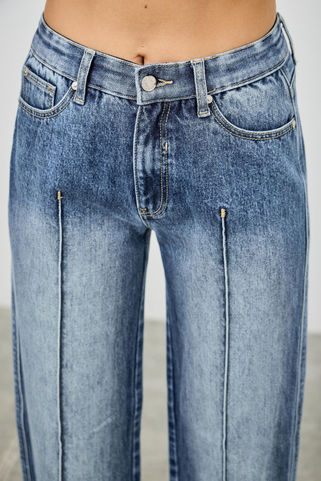 Close-up of pintuck blue jeans 