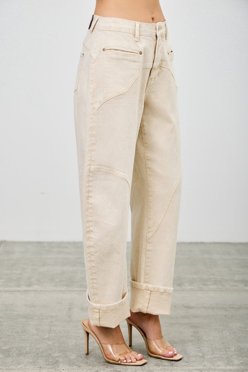 Beige western barrel jeans worn by a model side view