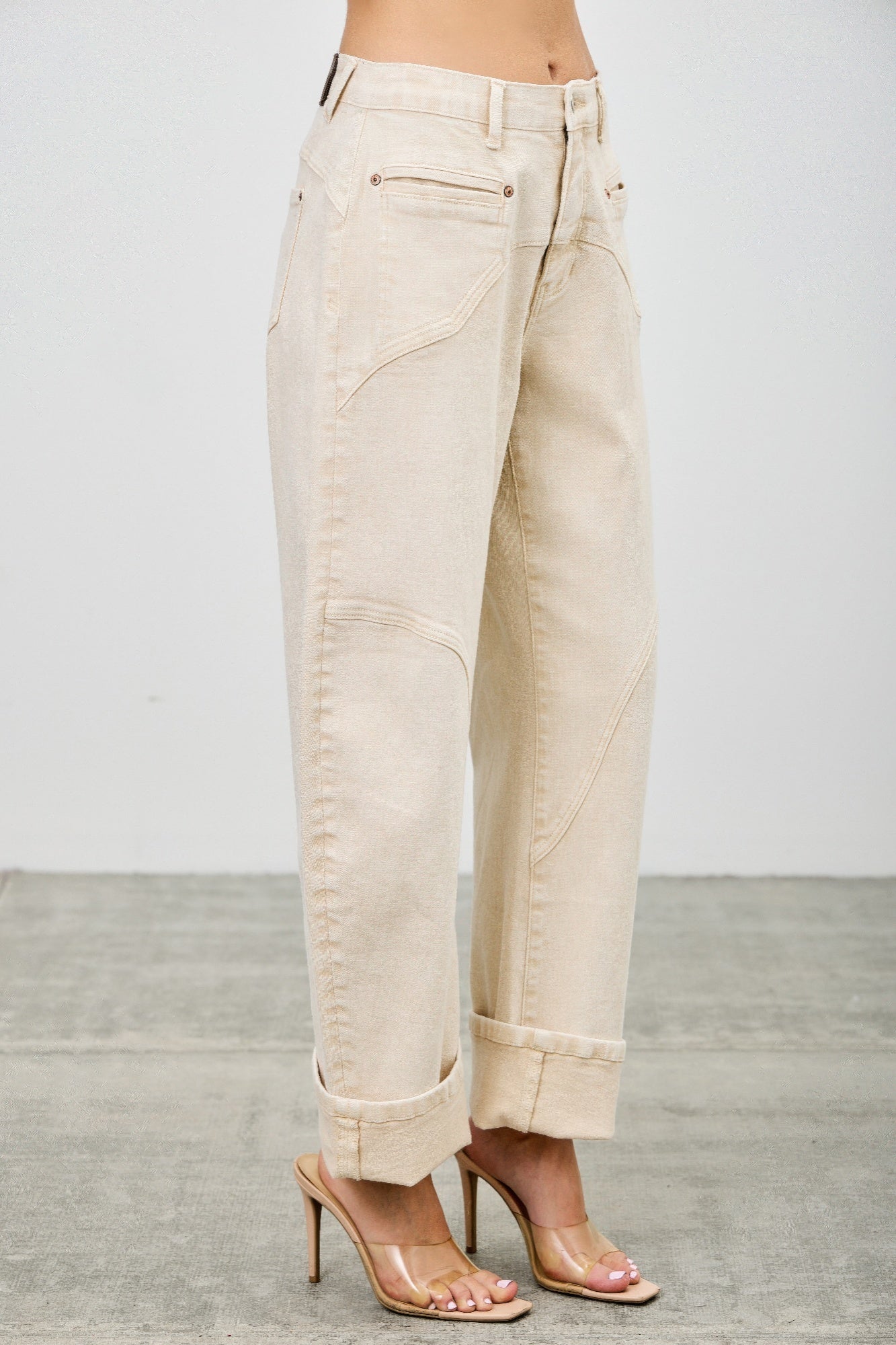 Beige western barrel jeans worn by a model side view