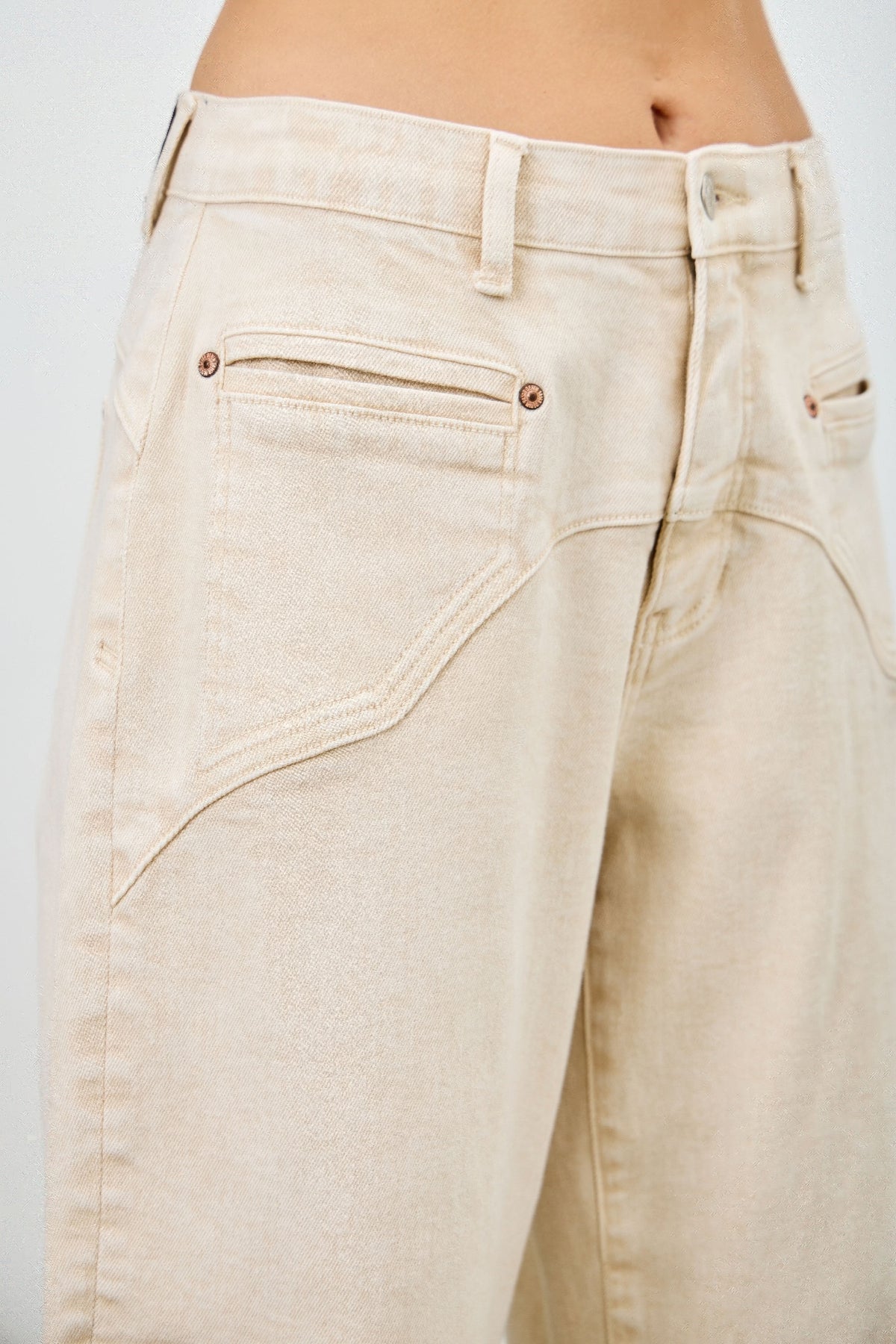 Beige wide-leg western barrel jeans close up