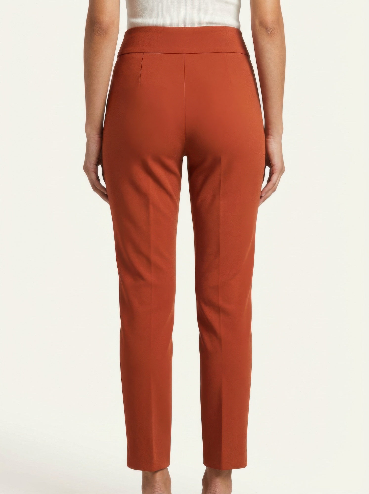 Brown pants worn by a person on a white background back view