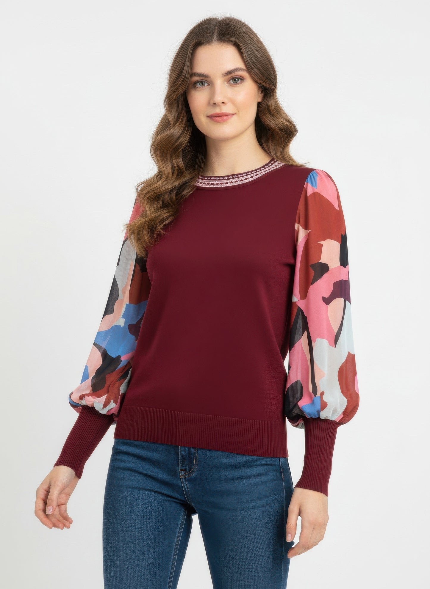 Woman wearing a burgundy rio & rian sweater with colorful sleeves 