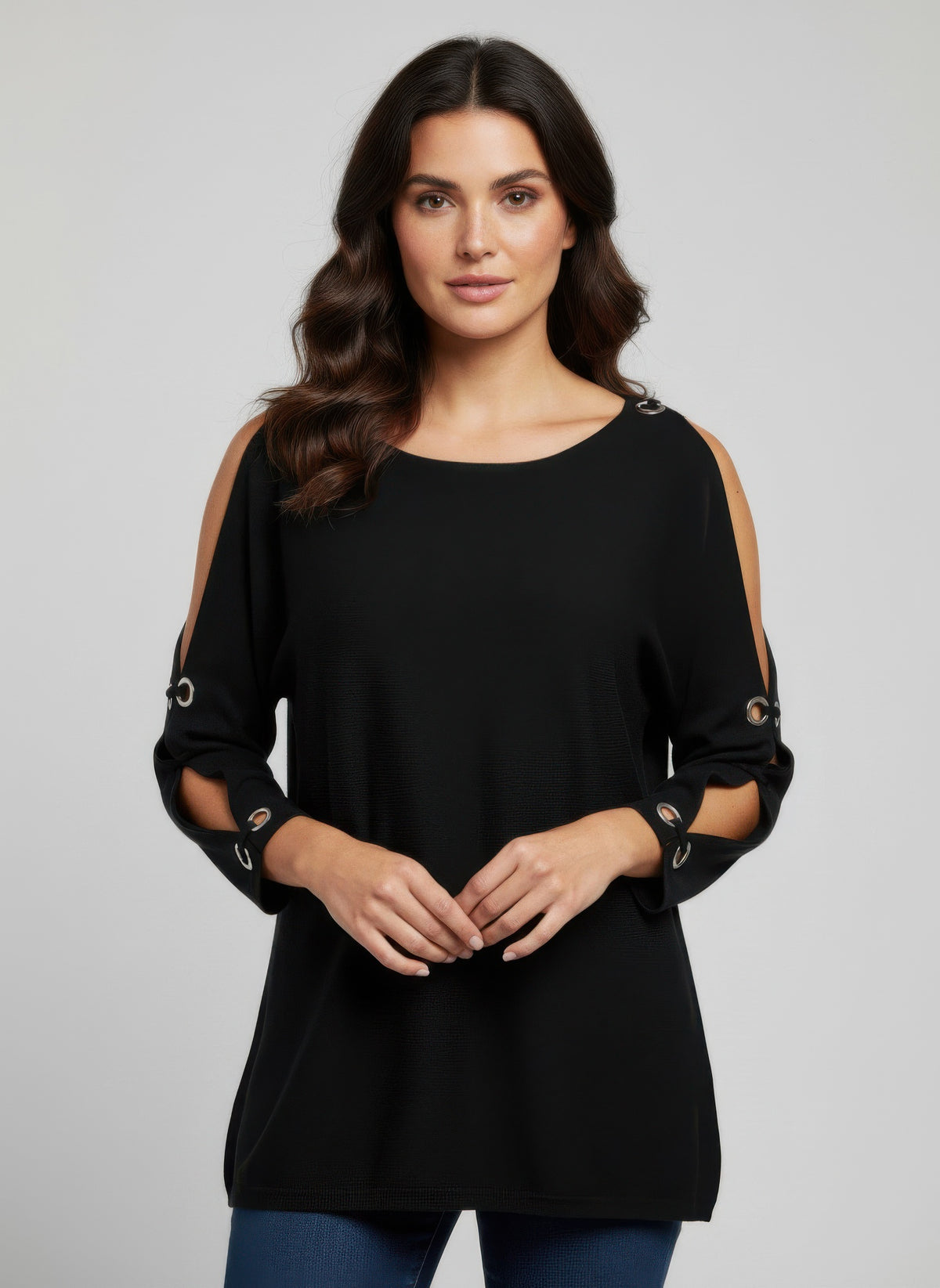 Woman wearing a black Cable & Gauge Pullover Sweater with cut-out shoulders.