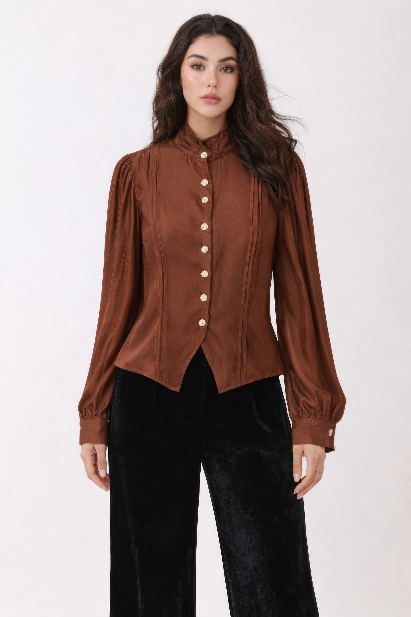 Woman wearing a brown Victorian blouse with buttons on a white background