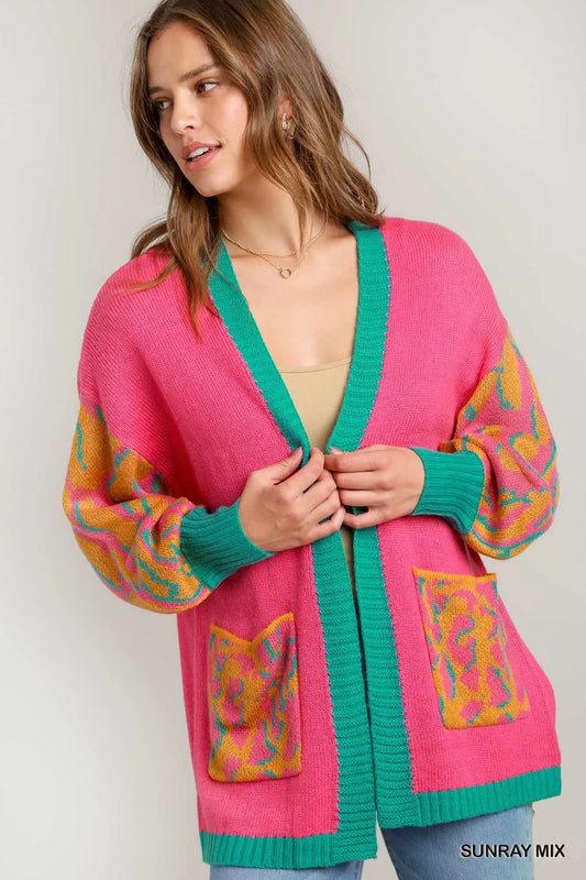 Model holding the cardigan, showing the cozy knit and bold colors.