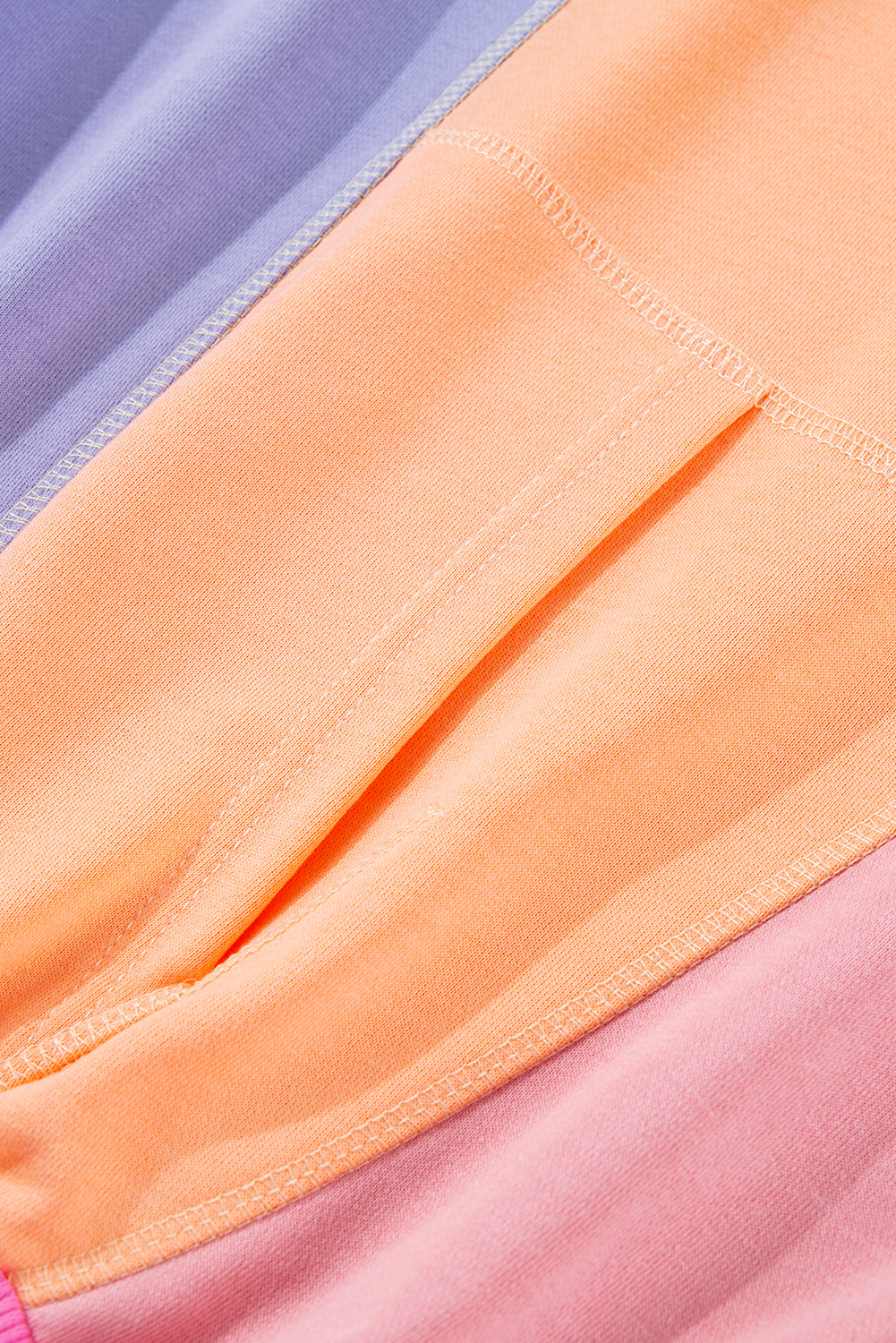 Detailed view of the soft fabric and colorblock design of a sweatshirt, showcasing the mix of pastel shades and comfortable fit.